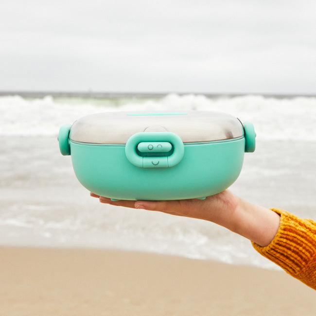 Kid Holding a Winck Stainless Steel Bento Box for Kids at the Beach