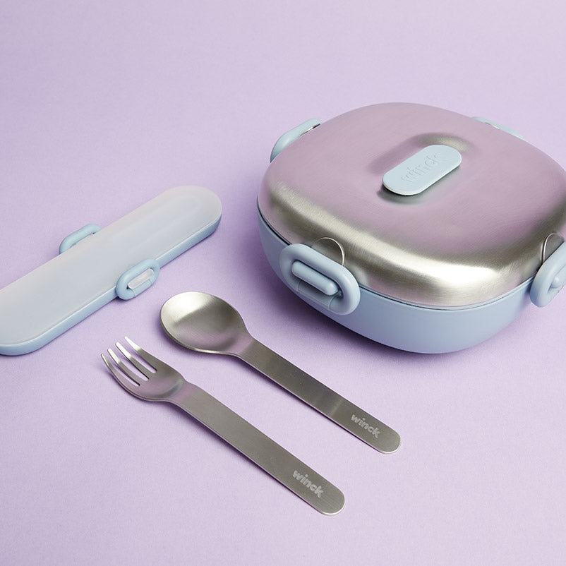 Winck Stainless Steel Bento Lunch Box for Kids and Winck Utensil Set in Berry which includes a stainless steel fork and spoon and carrying case, presented on a gentle purple background for an appealing mealtime set.